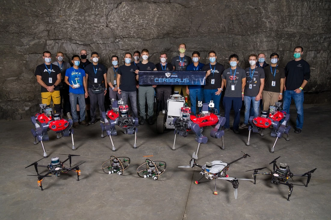The Team CERBERUS members with their multicopter drones and ANYmal C quadruped robots