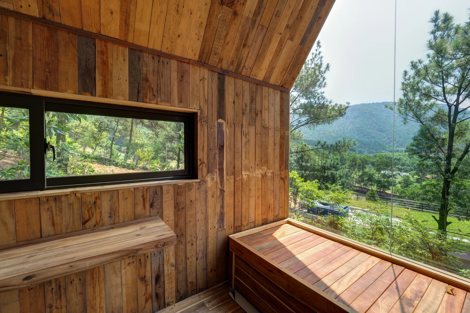Forest house features in-built furniture, including the sleeping quarters and bench seating