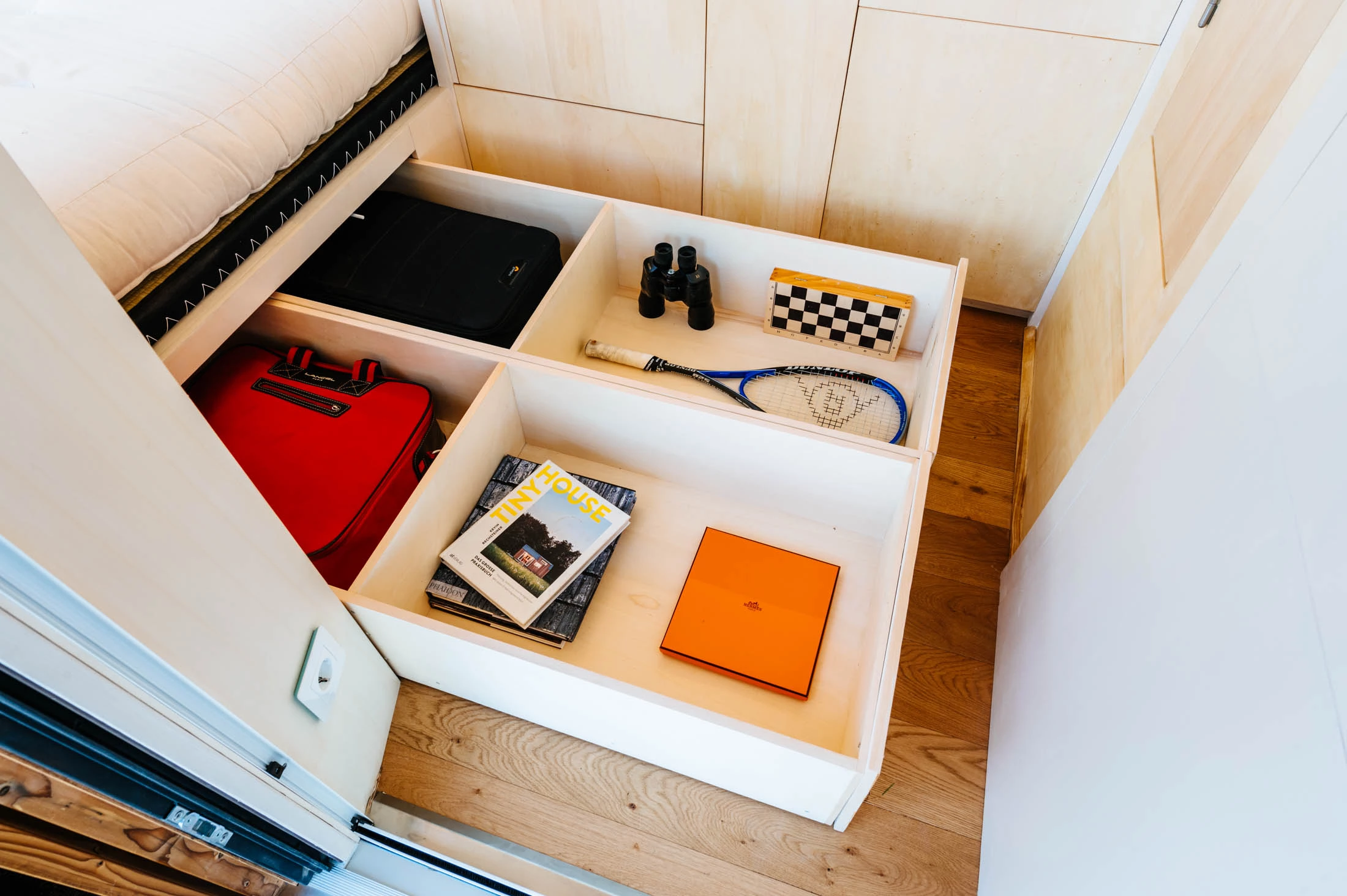 The Freeland Tiny House's bed contains generous integrated storage space
