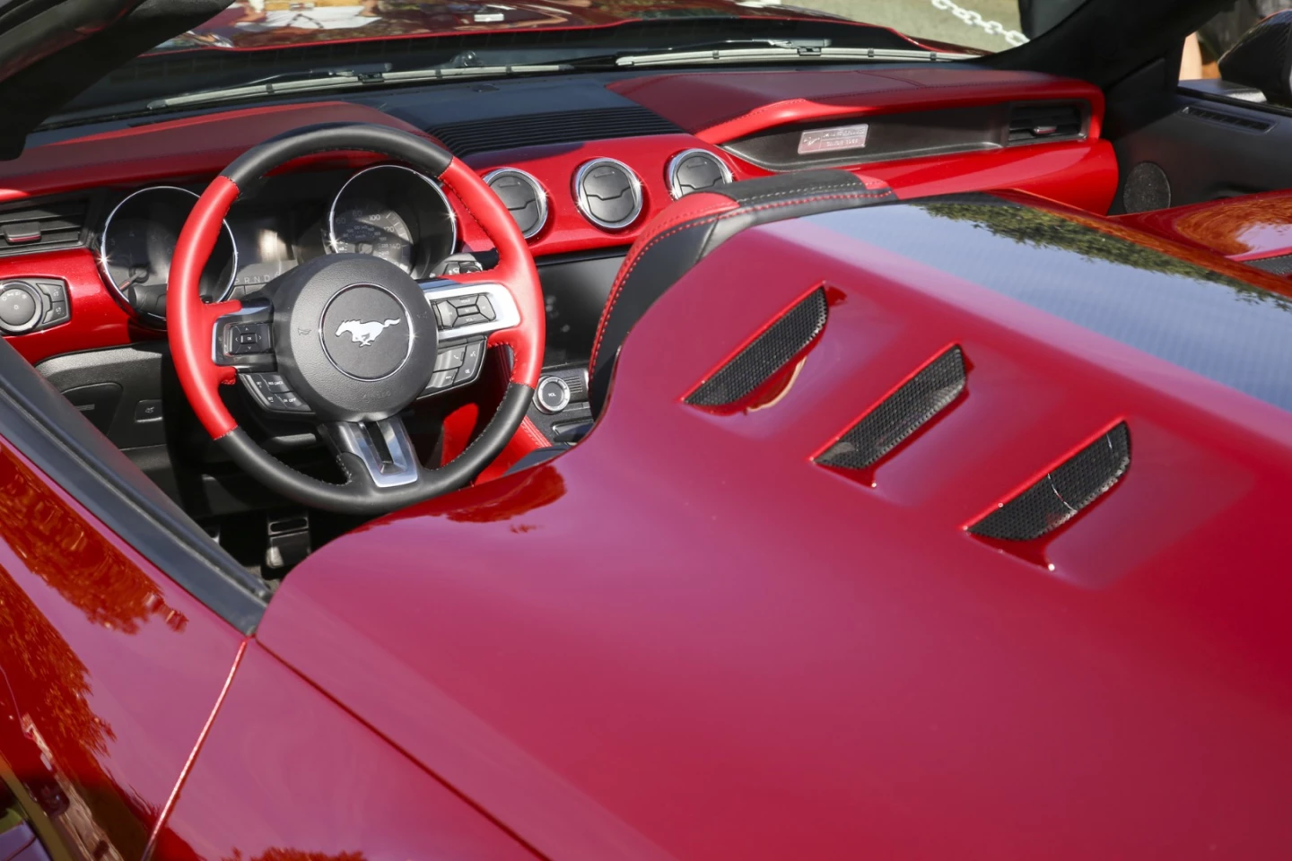 The carbon cover sits over the rear seats and includes mesh-covered air outlets