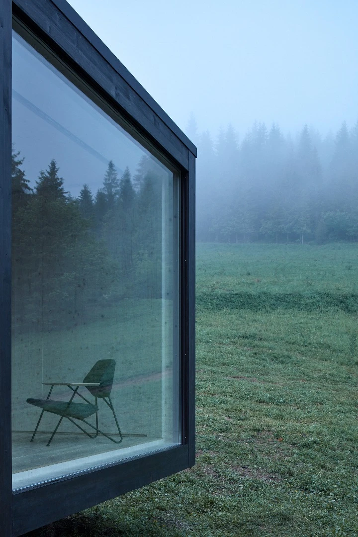 The Into the Wild cabin by Ark Shelter features a large glazed window to invite nature inside