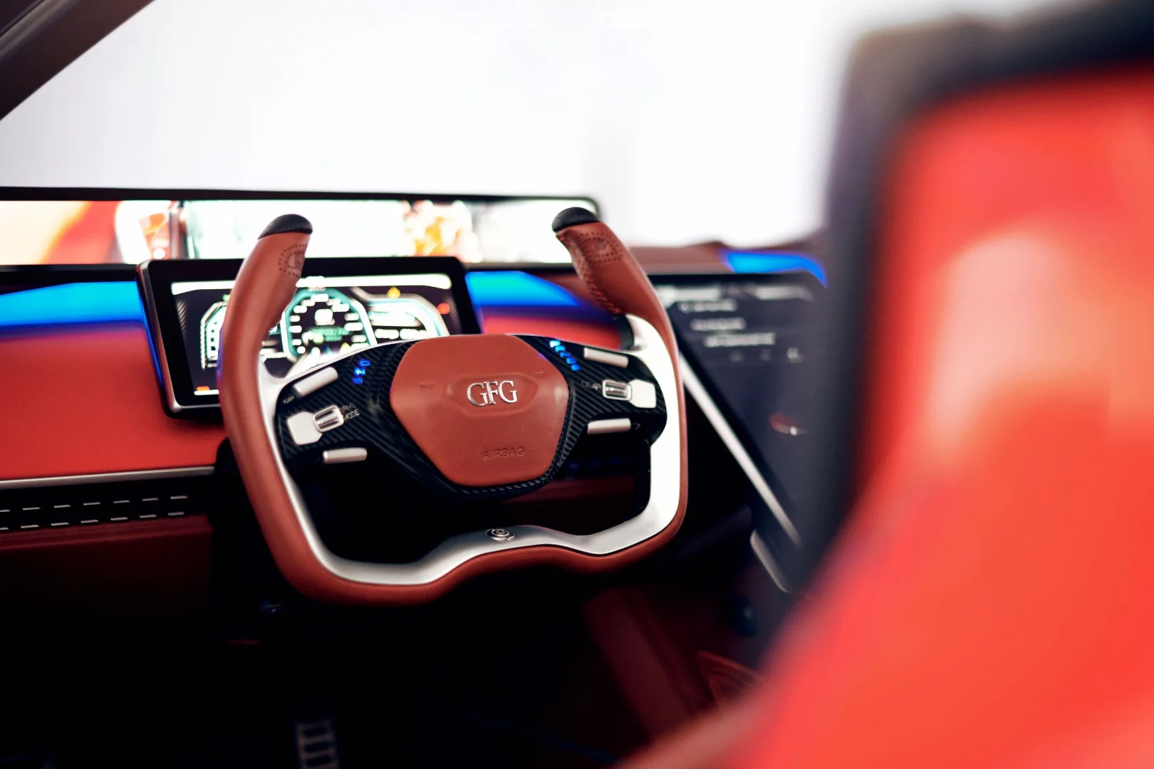 The display immediately behind the steering wheel serves as an instrument panel while the one higher up works as a digital rear-view