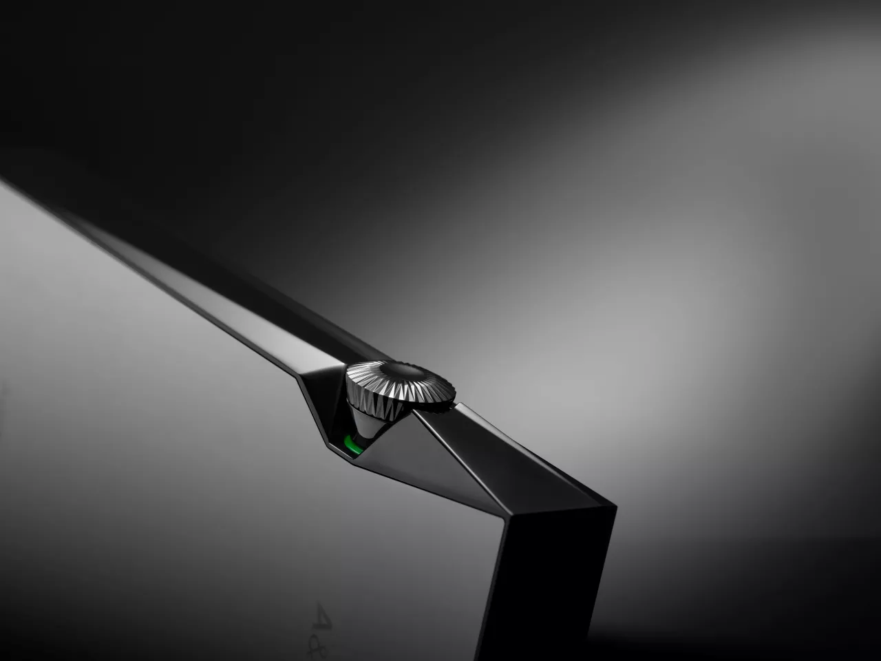 A watch-style crown for volume control matches the watch-grade body material