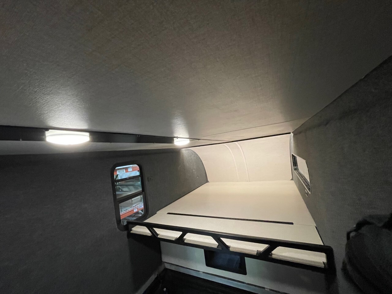 High Altitude keeps weight and price down with a DIY interior that includes only basics like lighting and a sleeper platform