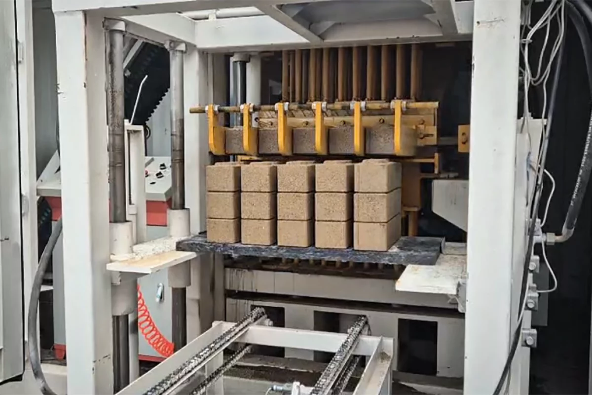 The mobile brick factory neatly stacks the bricks as it pops them out