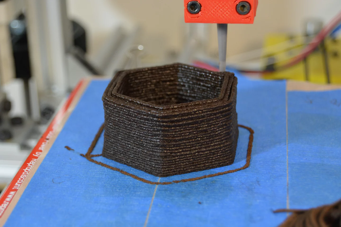 A 3D printer deposits the paste to print a plant pot