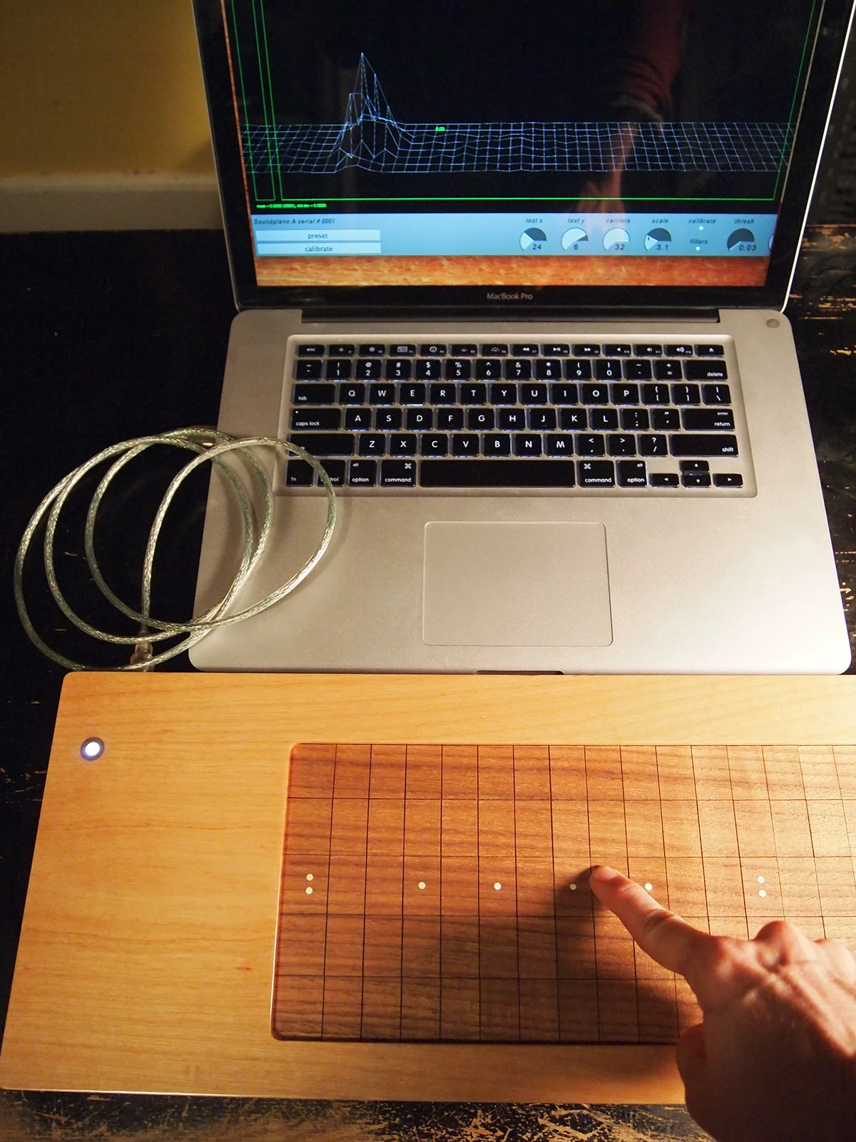 The Soundplane Model A computer music controller has a touch-sensitive walnut playing surface that can be played as 150 note keyboard or as one continuous surface