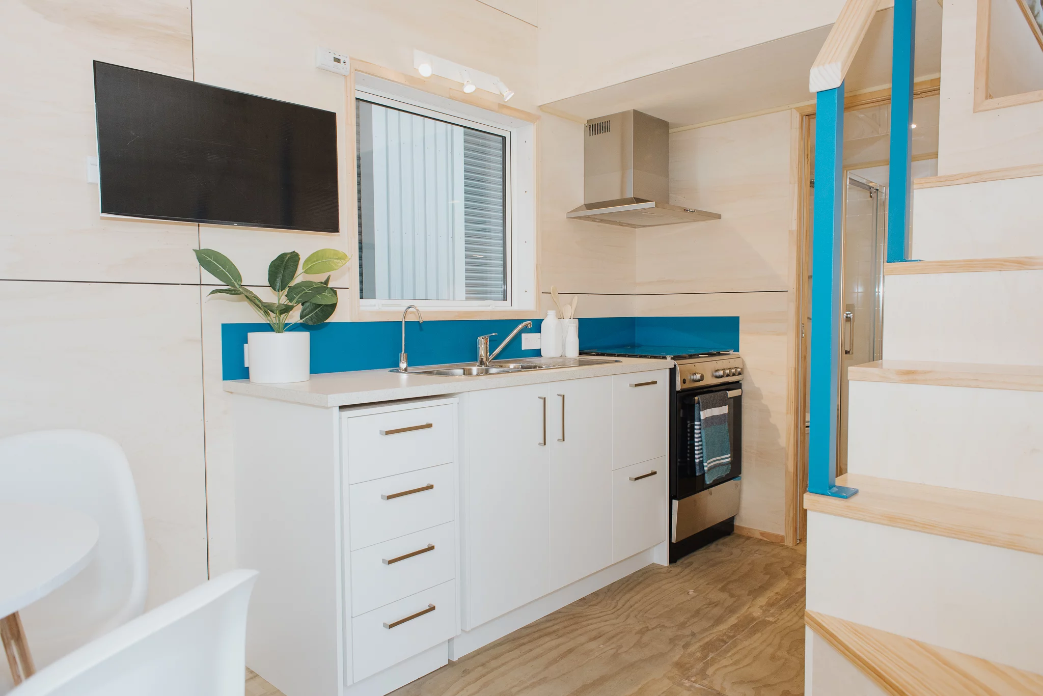 The Total Grace's kitchen includes a sink, oven and range hood, fridge/freezer, and cabinetry