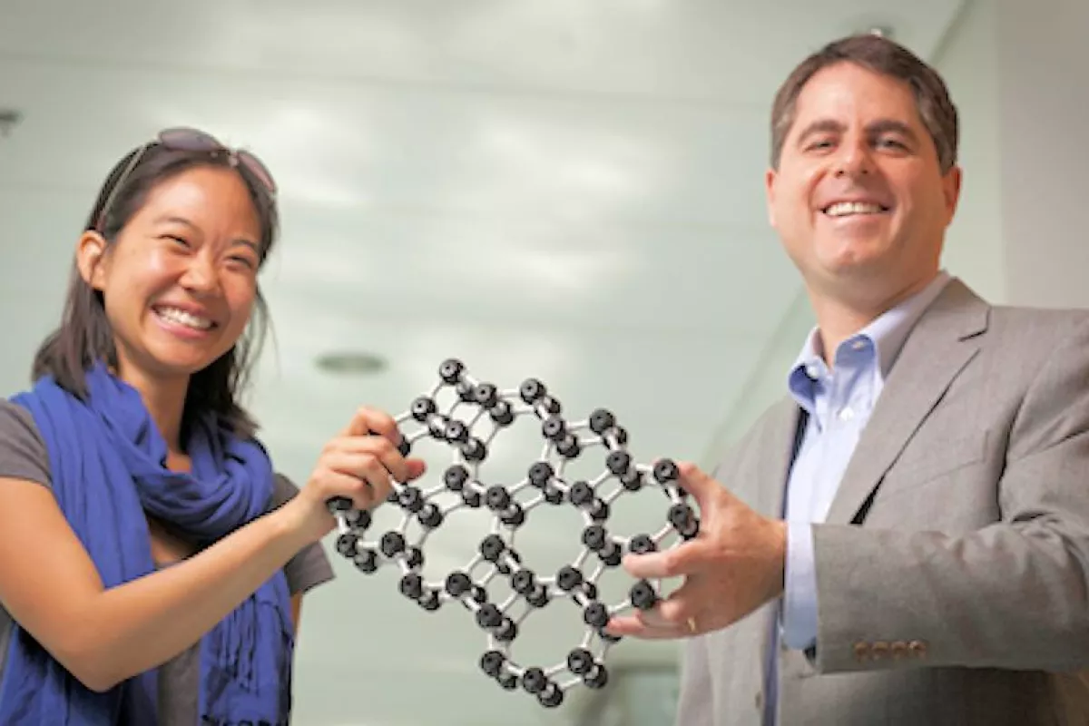 Cornell professor David Muller and grad student Pinshane Huang show a model of the atomic structure of the world's thinnest glass (Photo: Cornell University)