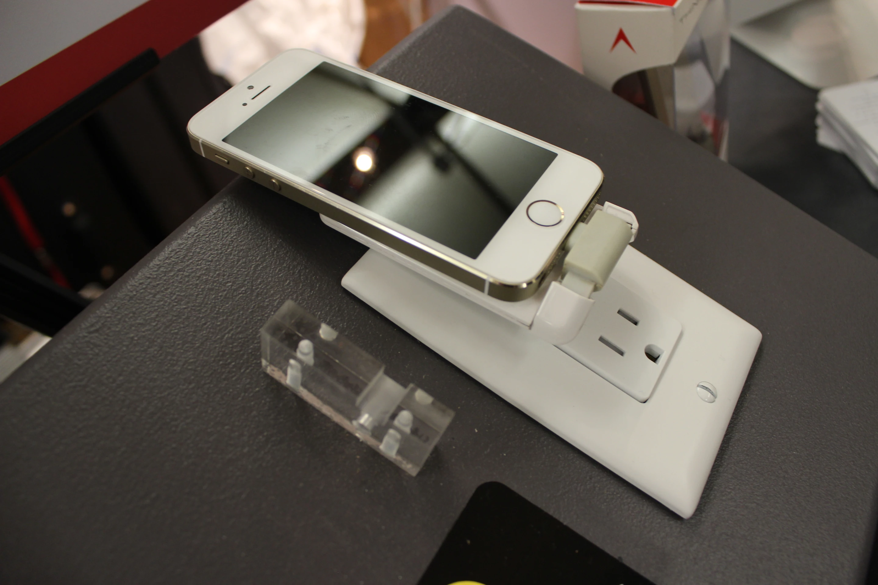 It sits in the outlet at a slight bottom-out angle, which helps keep the phone in place by tipping it back