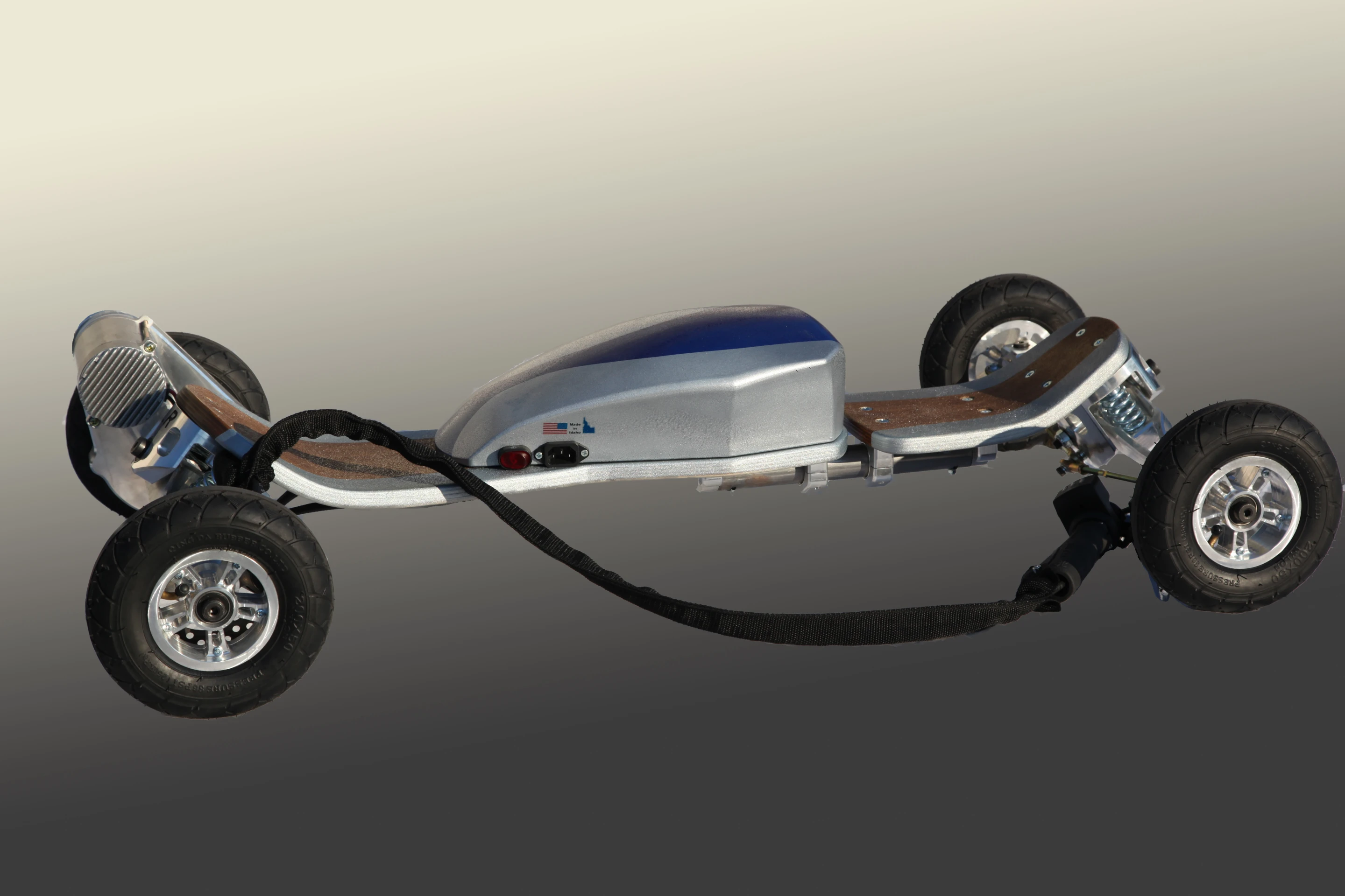 The RoamBoard features a rear-mounted 450 watt DC motor controlled by a 2-inch nylon tethered hand controller with thumb throttle and three-level LED charge indicator