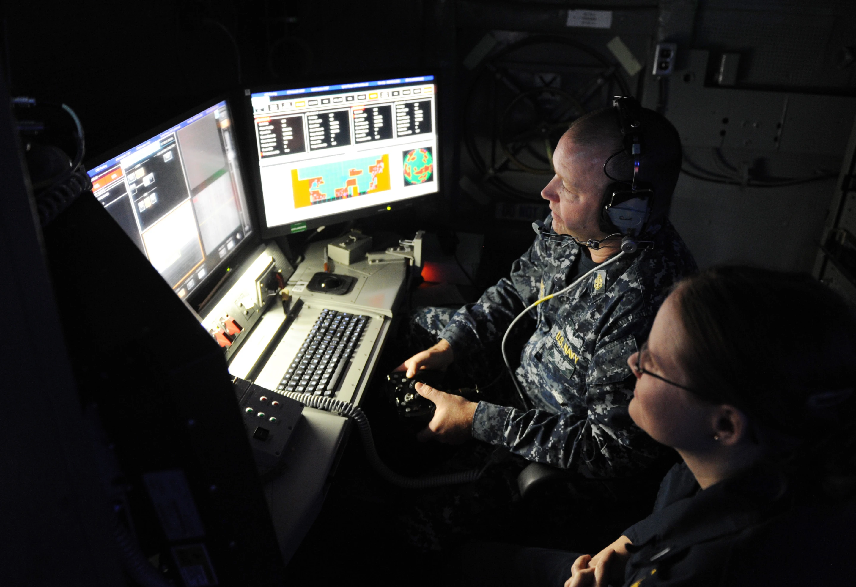 Chief Fire Controlman Brett Richmond and Lt. j.g. Katie Woodard operate the Office of Naval Research (ONR)-sponsored Laser Weapon System (LaWS)