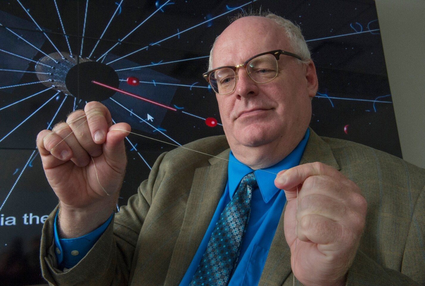 NASA engineer Bruce Wiegmann, principal investigator for the HERTS E-Sail, demonstrates the long, thin wires that will construct the E-Sail
