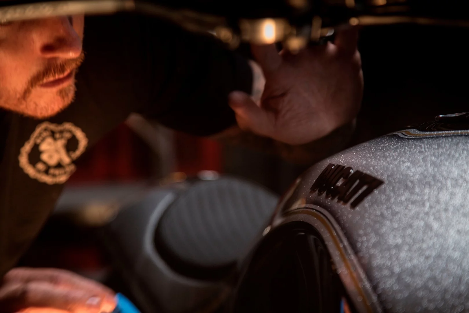 Roland Sands contemplates the sparkle paint job of his XDiavel custom in a serious manner