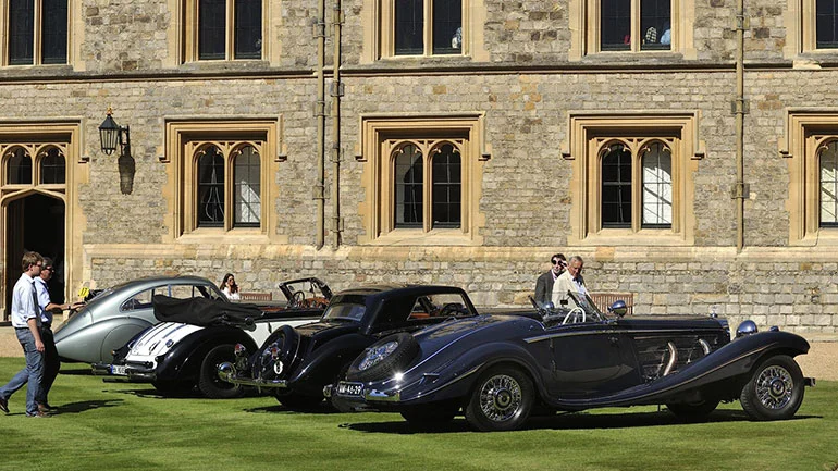 Vintage Bentleys and a Mercedes lined up in front of Windsor Castle