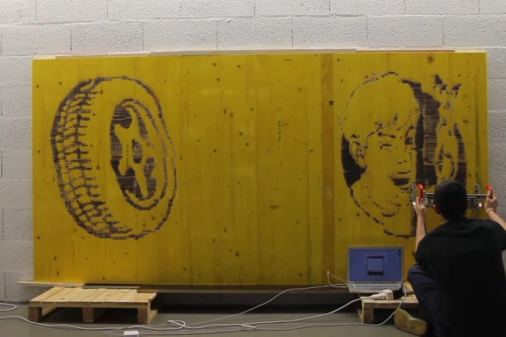 The FireWriter is a handheld printer that burns pictures onto wood with a torch, while an optical sensor keeps track of the image's positioning