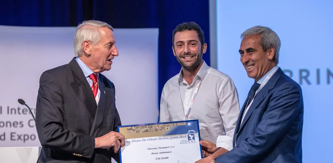 Vincenzo Navanteri (middle) accepts the $20,000 award for his self-piloting drone ambulance idea