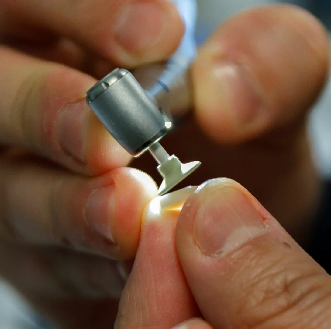 A slice of tooth is prepared for testing with the new filling material and adhesive