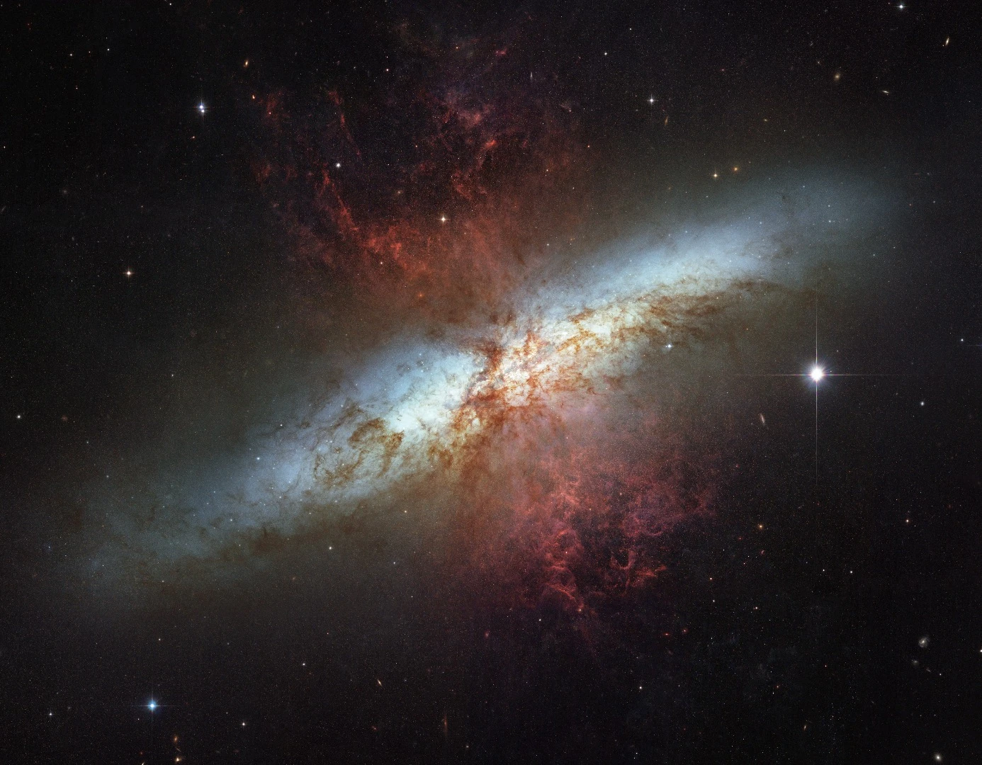 This mosaic image of the magnificent starburst galaxy, Messier 82 (M82) is the sharpest wide-angle view ever obtained of M82. It is a galaxy remarkable for its webs of shredded clouds and flame-like plumes of glowing hydrogen (Credit: NASA, ESA and the Hubble Heritage Team (STScI/AURA). Acknowledgment: J. Gallagher (University of Wisconsin), M. Mountain (STScI) and P. Puxley (NSF)
