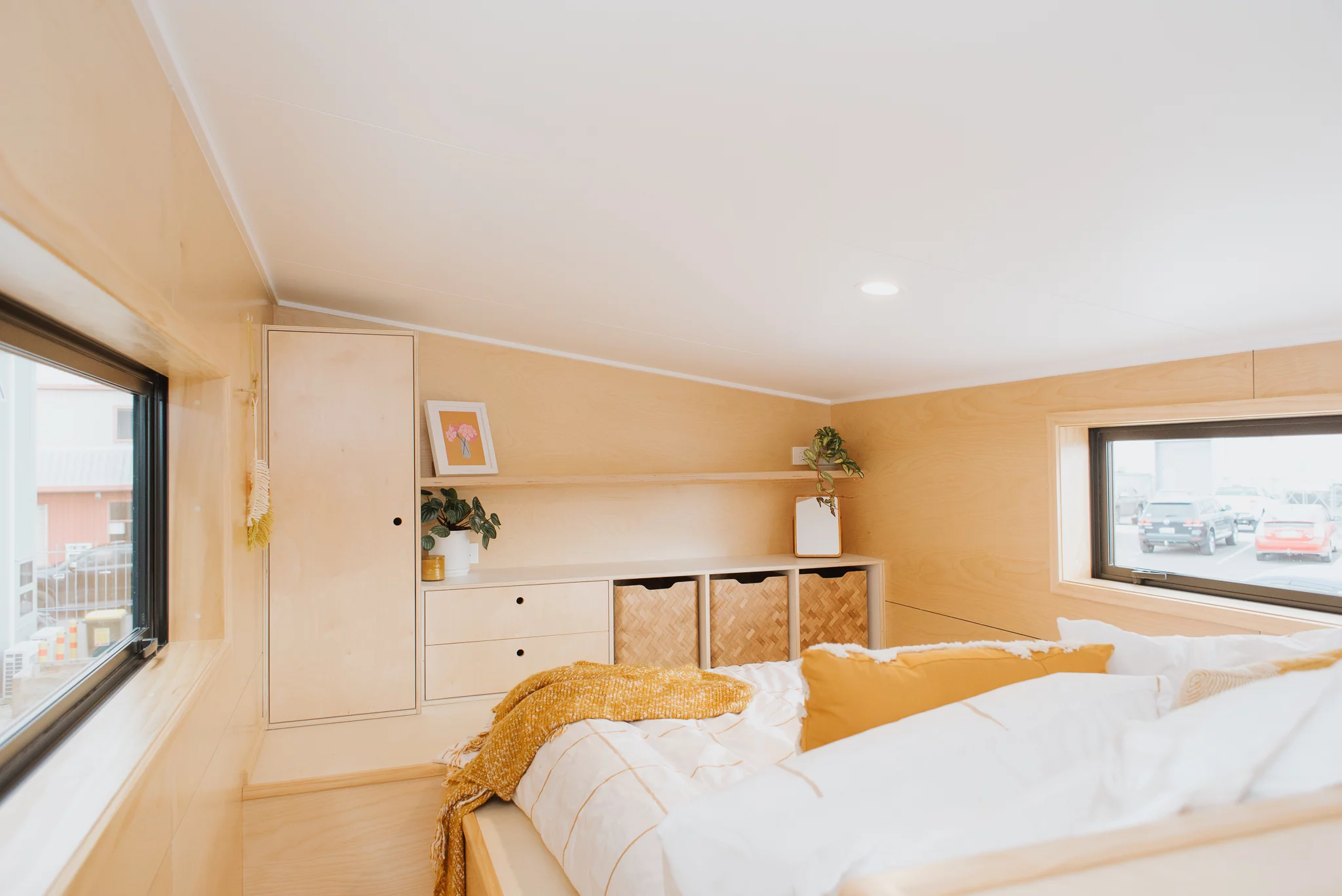 The Kererū Tiny House's main bedroom has quite a lot of storage space available