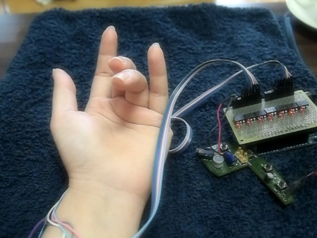 PossessedHand stimulates muscles in the forearm to move a wearer's finger (Photo: Emi Tamaki and Jun Rekimoto / University of Tokyo)