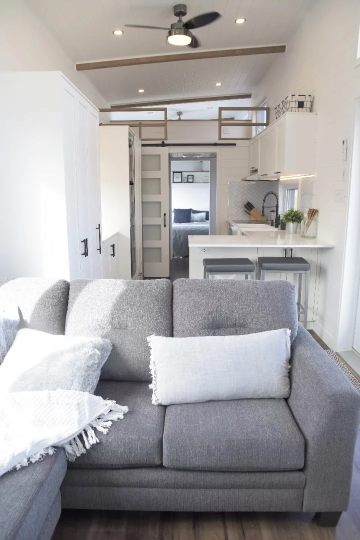 The Magnolia's living room includes a sofa and entertainment unit