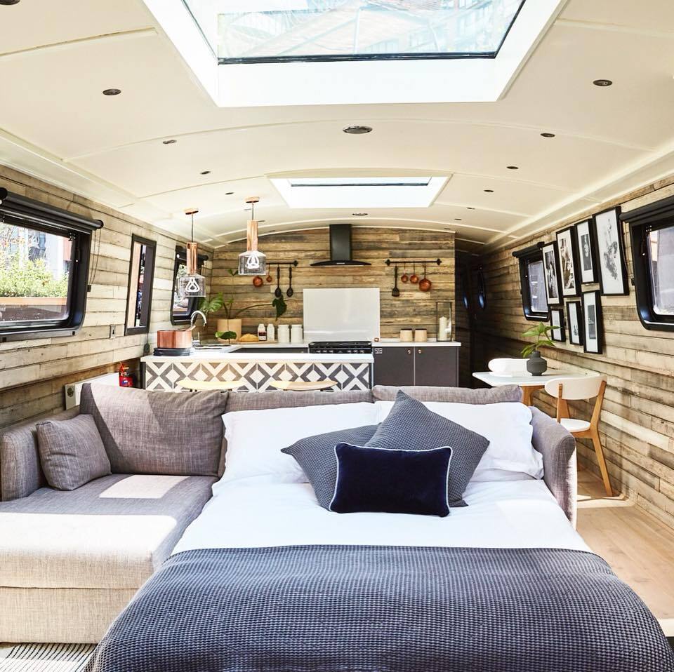 The Boathouse London features an open living area with large sofa that can covert into an additional double bed