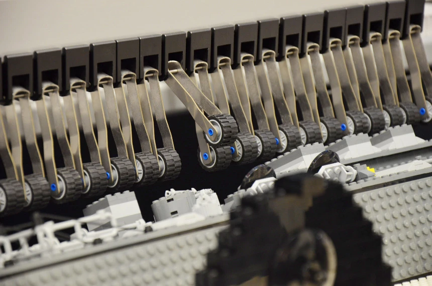 The bricks on the surface of the barrel strike arms that trigger keys on the built-in keyboard