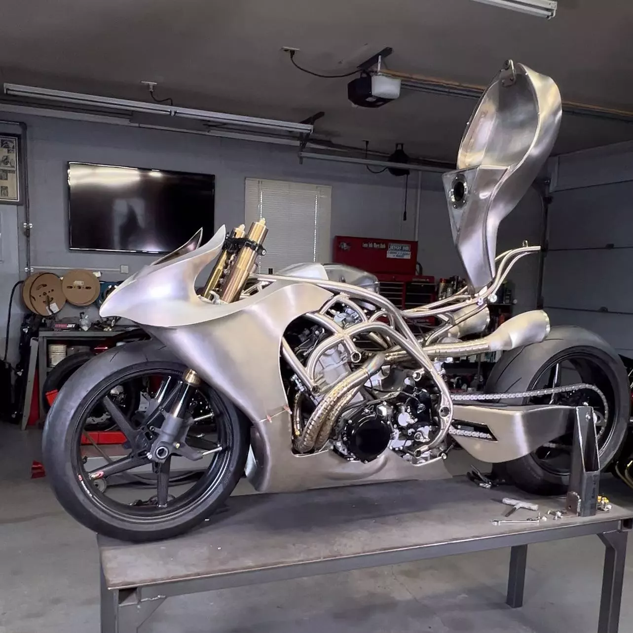 The titanium bodywork is complete, including the tail (not shown here) and the fuel tank, which flips up for access to the engine