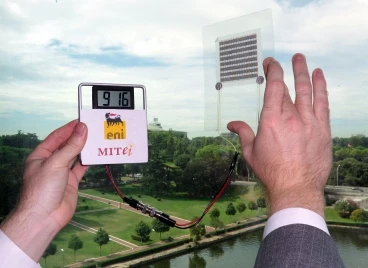 A paper solar cell, which has been laminated in plastic, is connected to an LCD screen to demonstrate that it is producing power from ambient sunlight(Image courtesy of the Gleason Lab)