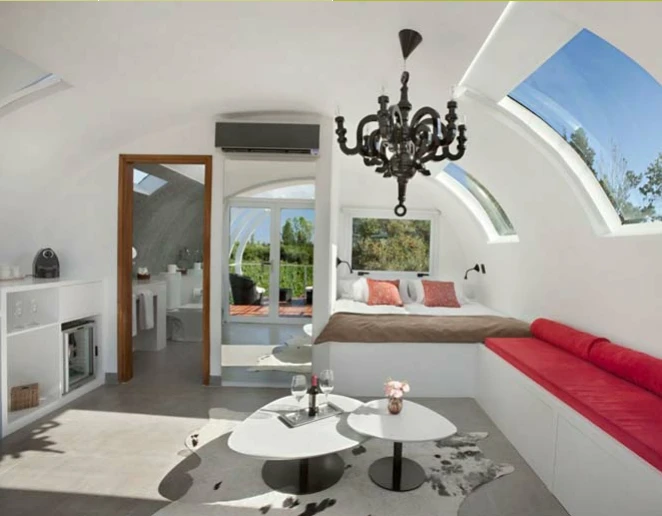The interior includes an open lounge area that morphs into the guest bed, a private bathroom, desk and minibar