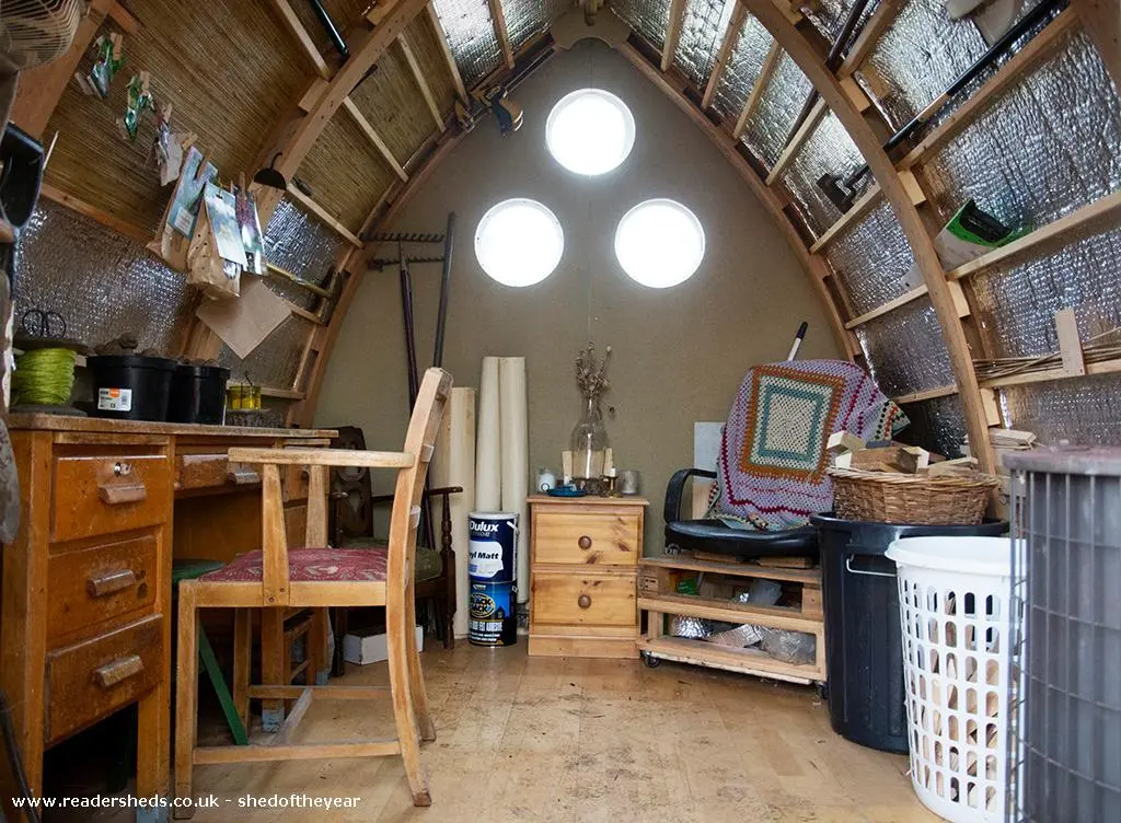 Shed of Dreams uses an unconventional roof construction, made by curving two members and then locking together to form a Gothic arch shape