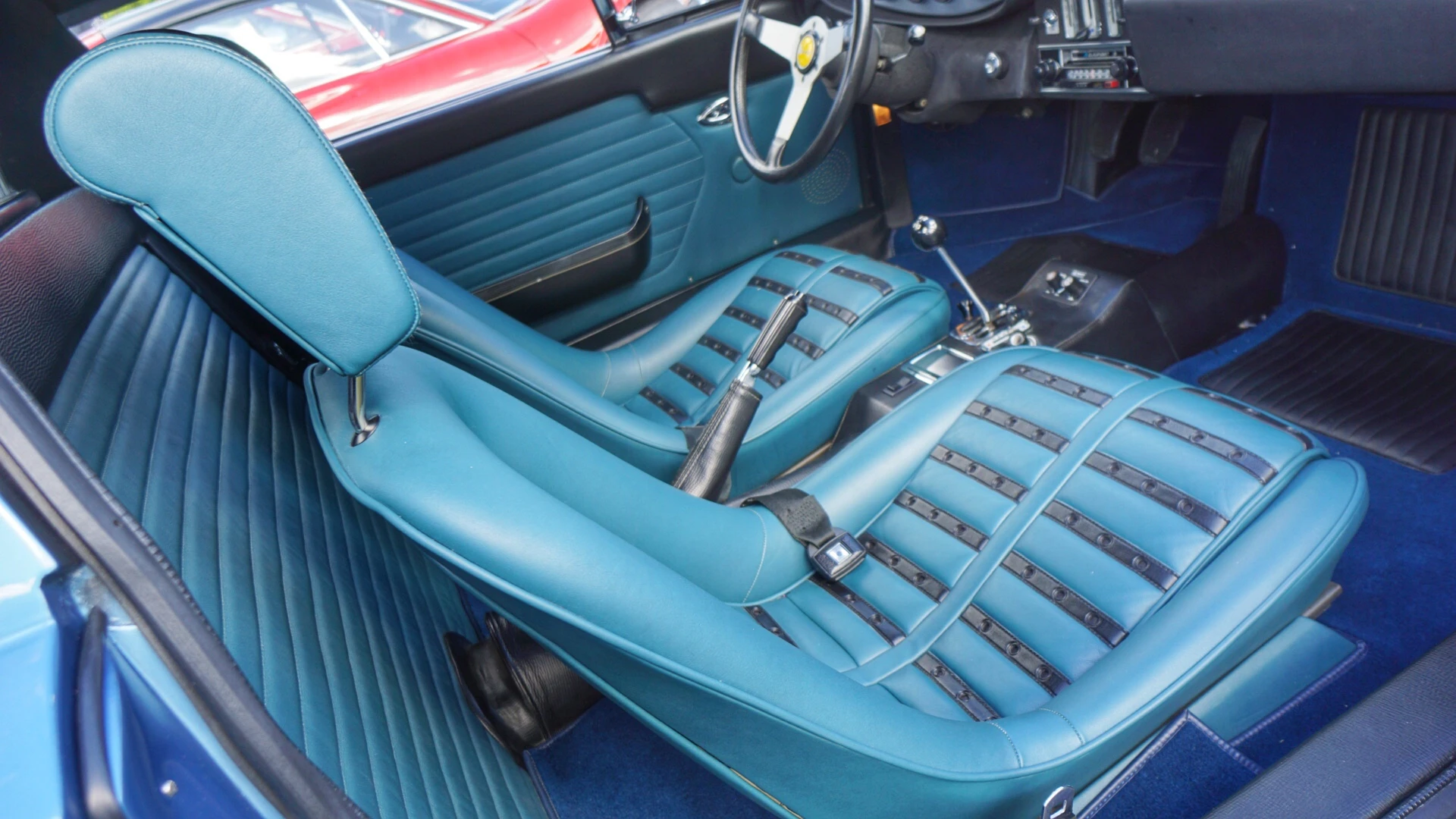 The 1974 Dino model was distinctive for what is referred to as "chairs and flares" because it had these seats with opposite color insets and small fender flares