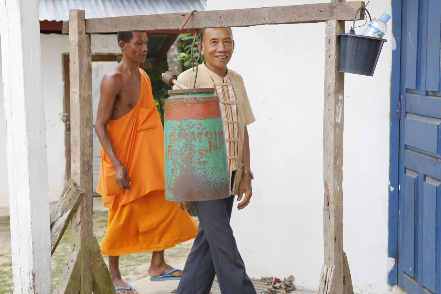 Geoff made a point of telling me to capture the image of the village head man walking past the school bell. Later he told me the headman still carried a piece of shrapnel in his shoulder from the Vietnam war. He'd been bombed in this village, and was an innocent bystander due to the village's proximity to the "Ho Chi Minh Trail" which ran through Laos to enable North Vietnam to resupply its attack on the South. The school bell to this day is part of an unexploded American bomb.