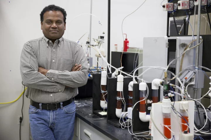 Pratap Pullammanappallil poses with an anaerobic digester used in a process that turns human waste into rocket fuel (Photo: Amy Stuart, UF/IFAS Communications)