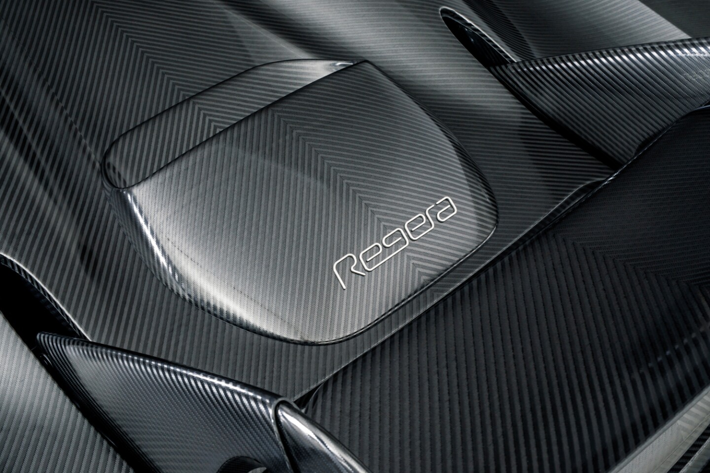 Koenigsegg's KNC Regera: the naked carbon has a graphite-like sheen as the light catches the strands