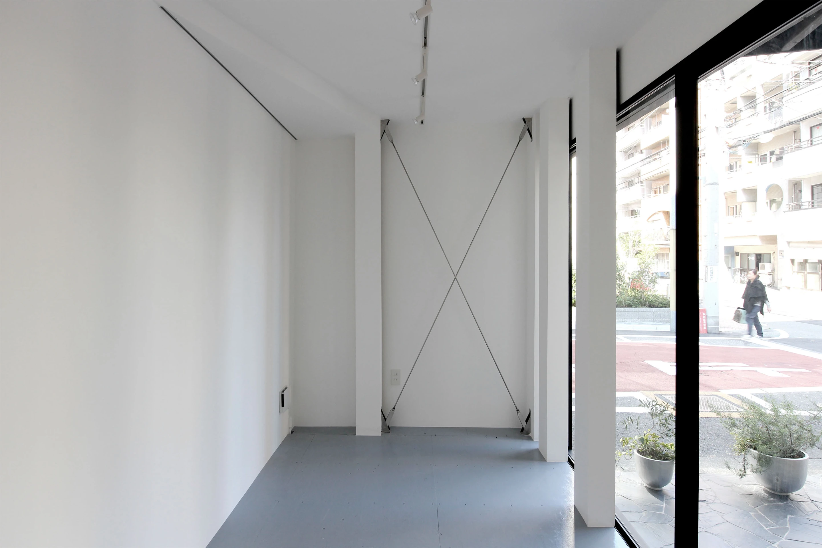 The interior walls are painted white to keep the space light and expansive, appropriate for an ever changing gallery space