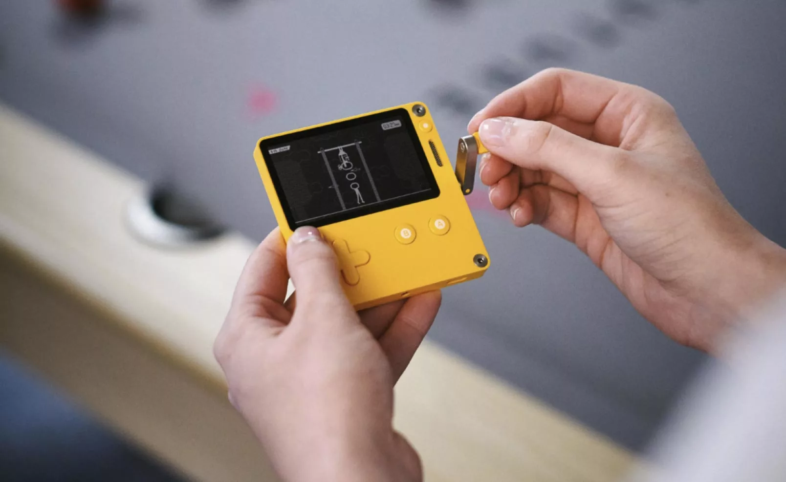 The crank-handle of the Playdate handheld games console in action
