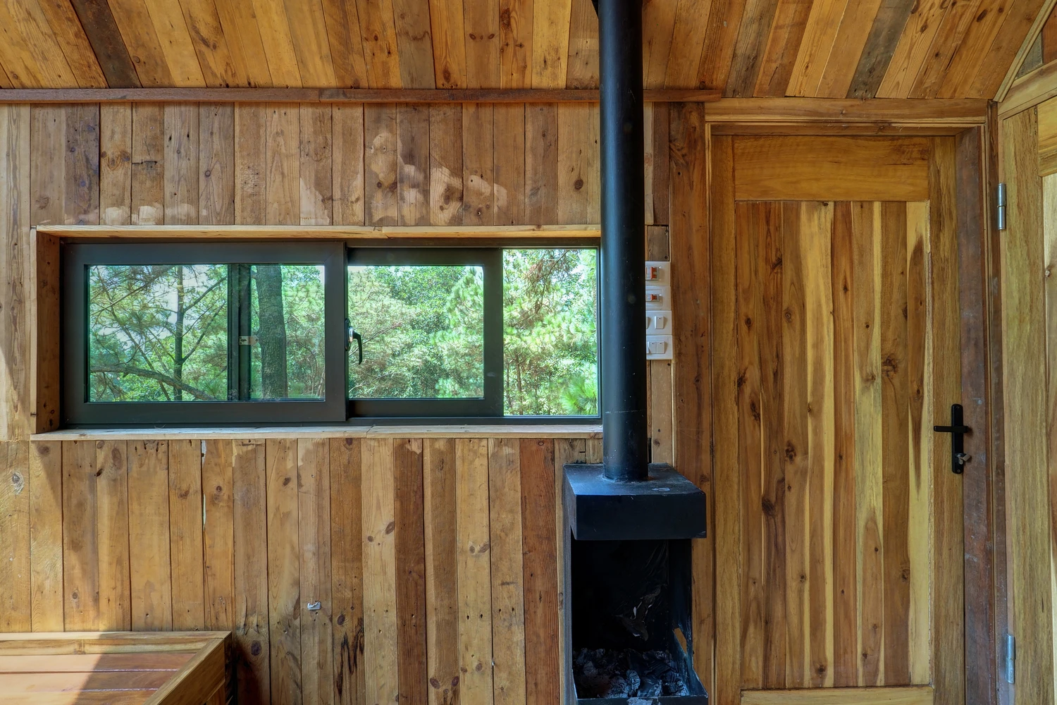 Forest house features a log fire and air conditioning for the different seasons