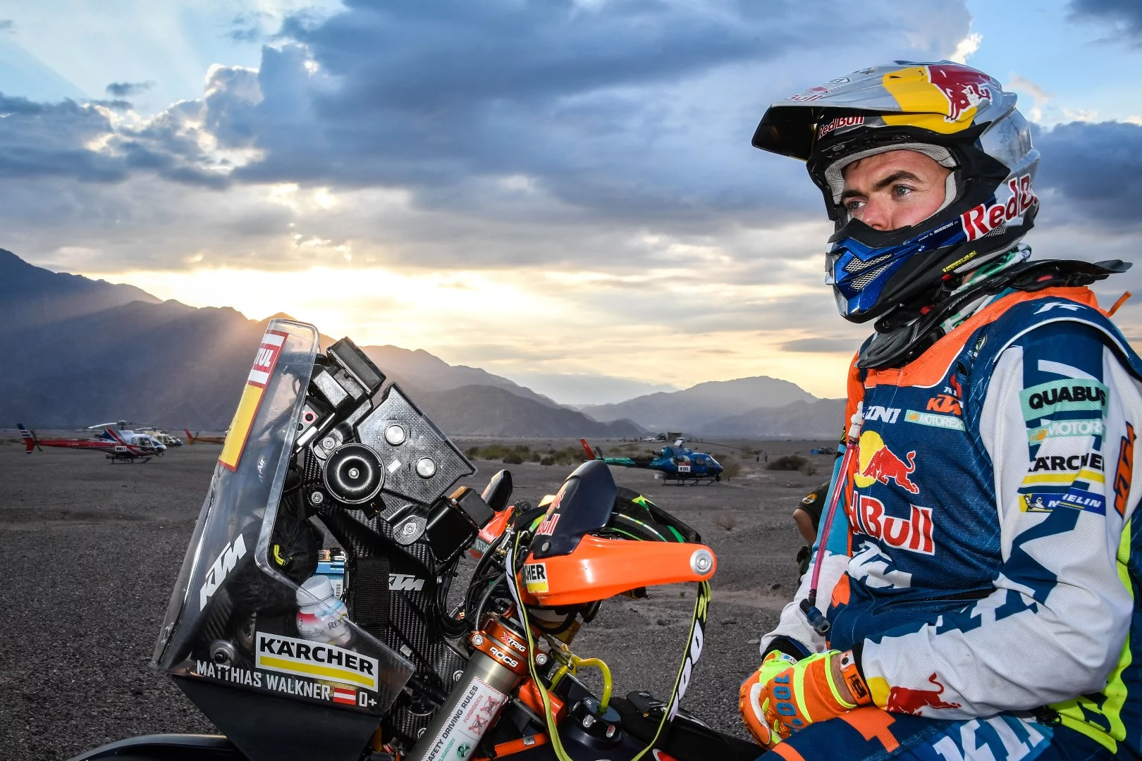 Motorcycle winner Matthias Walkner pauses for a portrait against the rising sun