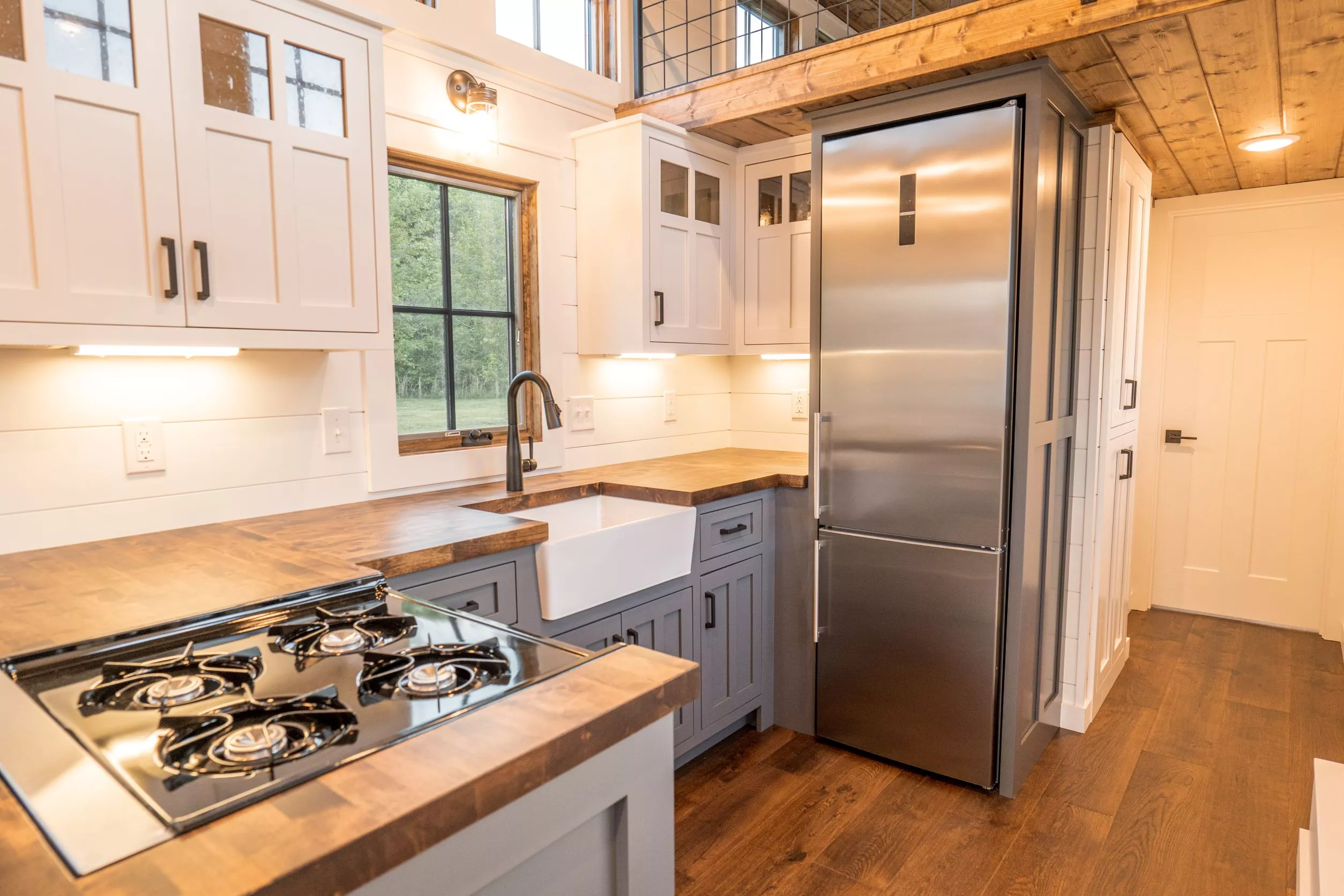The Teton's kitchen looks well-proportioned for a tiny house and includes a full-size fridge/freezer
