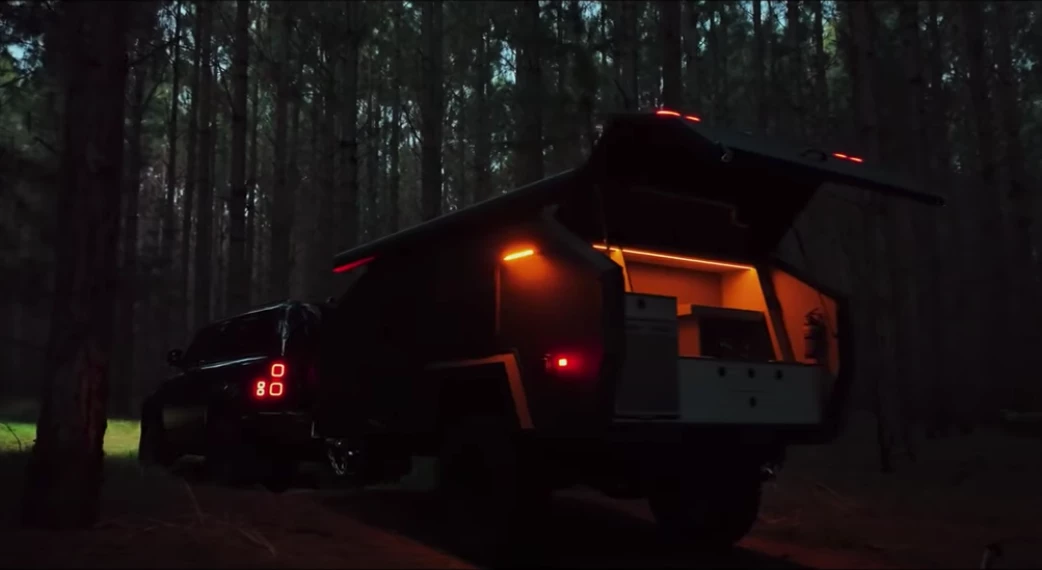 The Bruder EXP-4 Stealth pops its tailgate galley after hours; the Stealth model is upgraded with a larger 80-L front-opening fridge