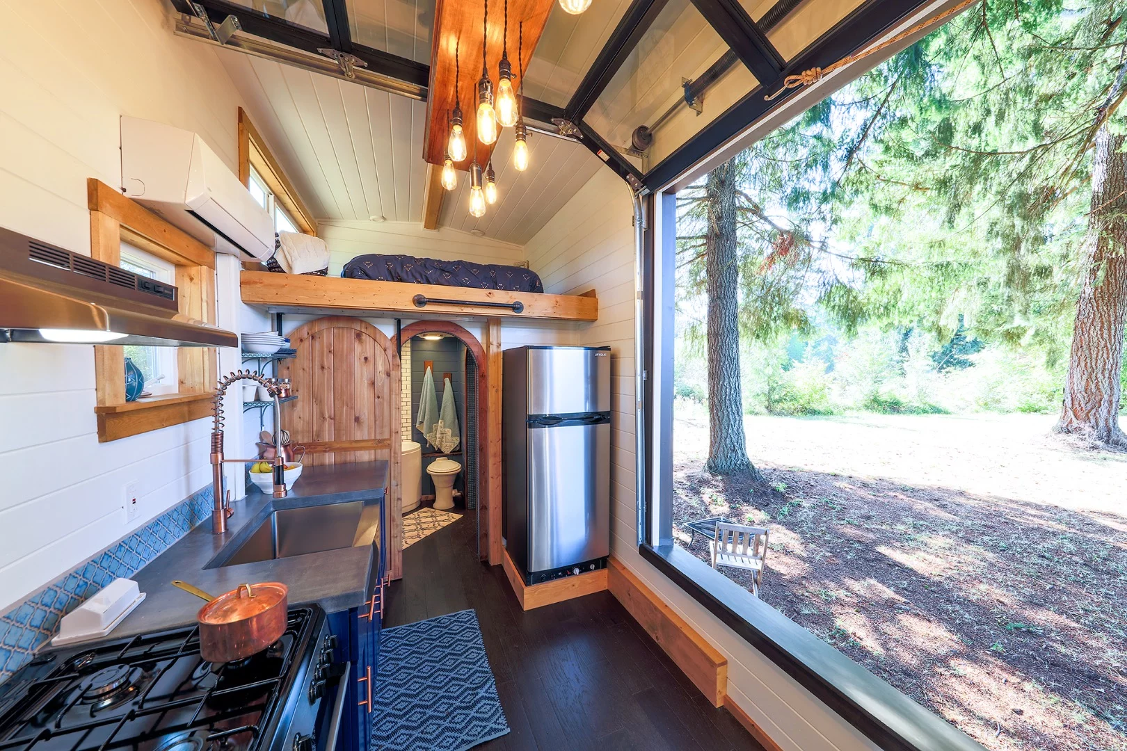 The Tiny Adventure Home opens to the outside with a large garage-style door