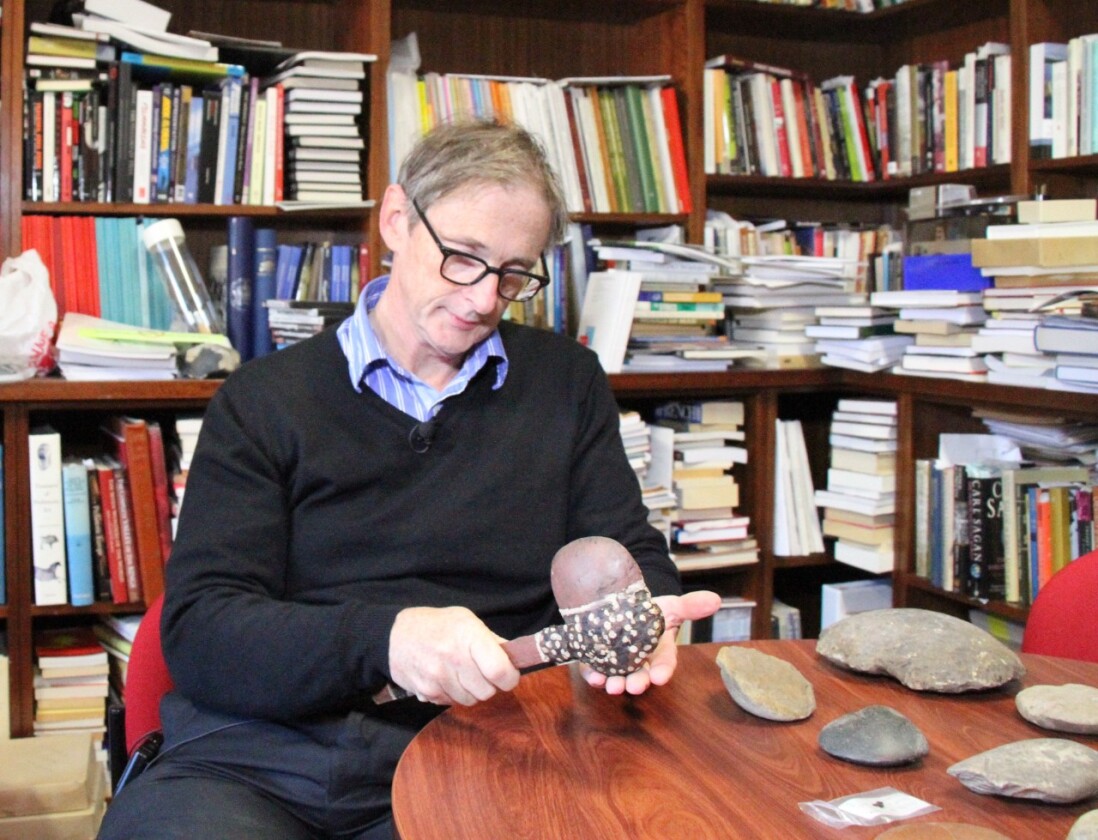 Professor Peter Hiscock, who led the study, holds a hafted axe – which he believes is indicative of the kind the fragment came from