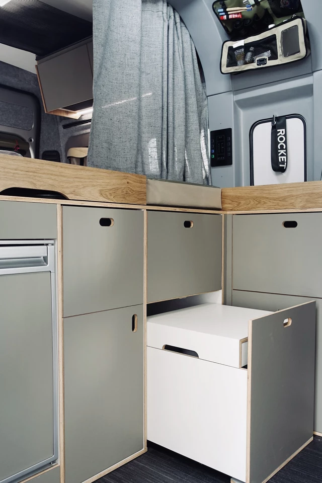 The slide-out toilet includes a hard lid to work as a step