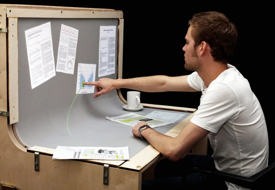BendDesk renders the horizontal desktop and vertical display screen into one multi-touch surface via a curve in the middle