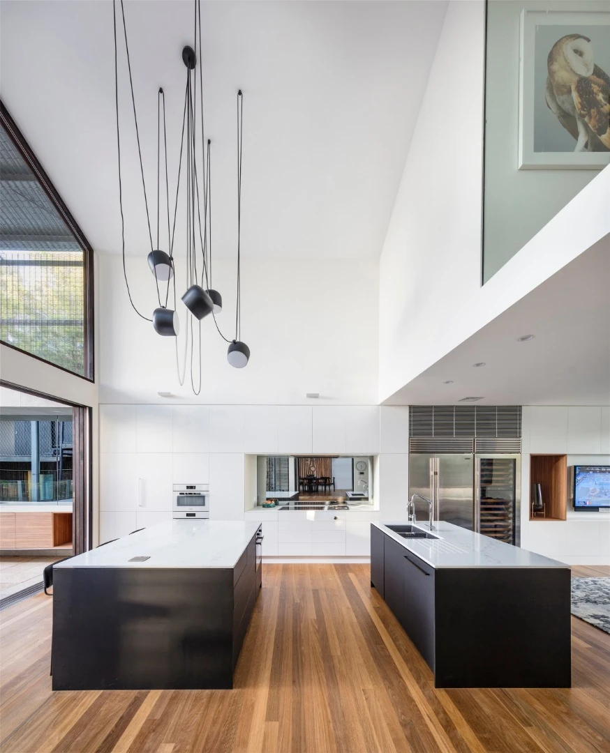 An open plan living and kitchen area opens up to a barbecue/outdoor dining area in the Iron Maiden House