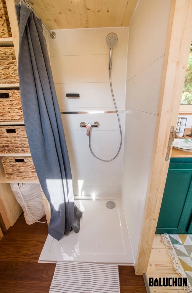 The Hauméa tiny house's bathroom includes a shower and toilet