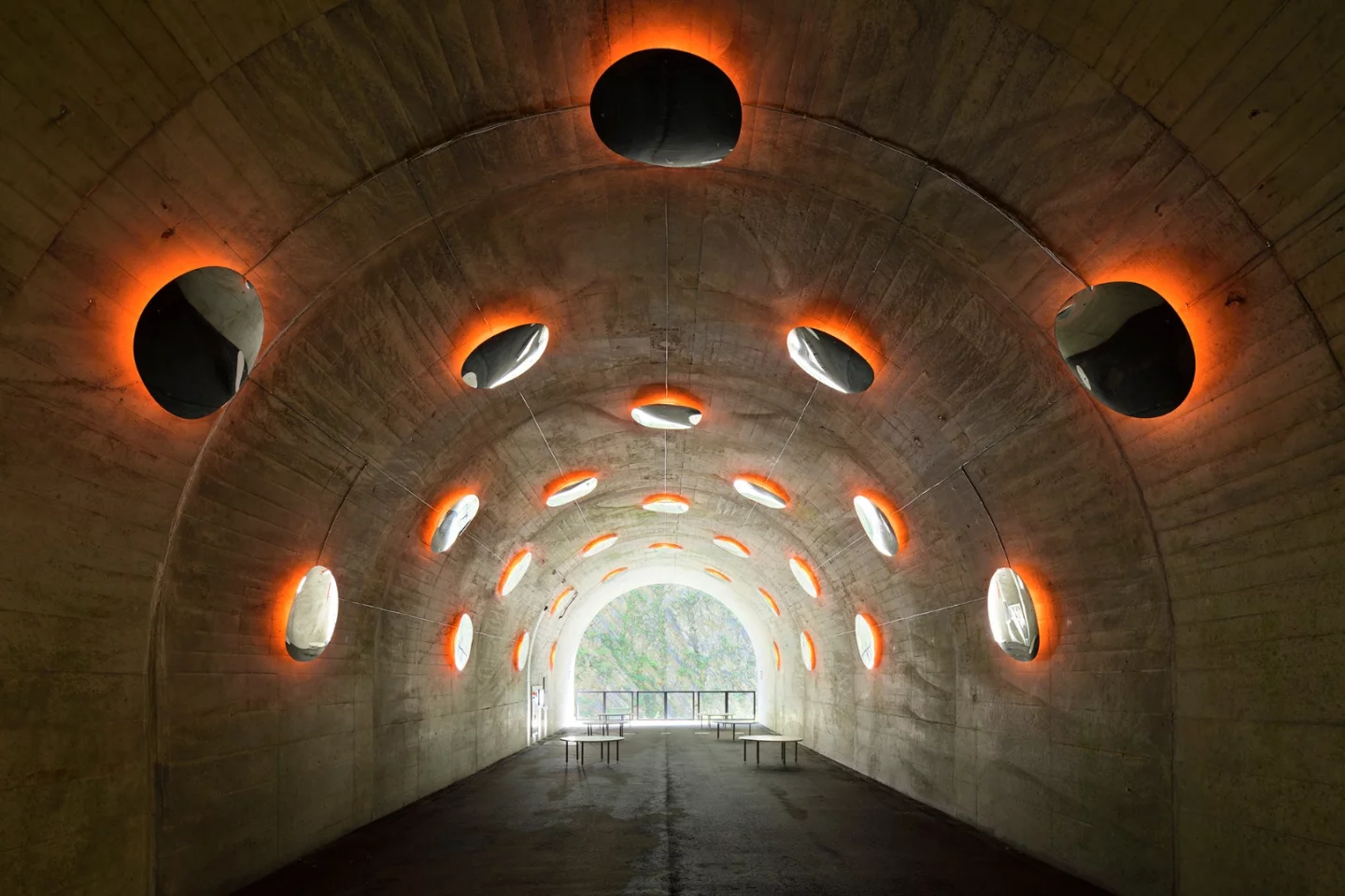 The "Fire" installation at the Kiyotsu Gorge Tunnel features convex mirrors that mimic molten blobs