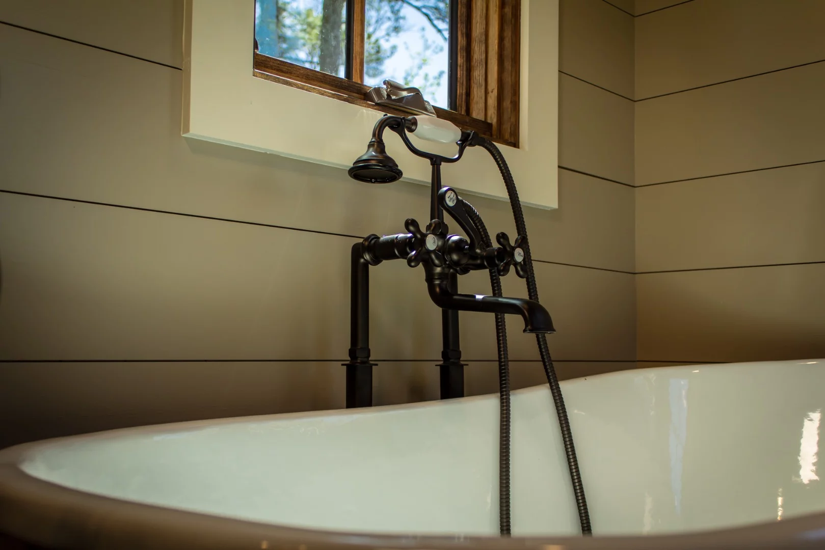 The Cedar House's bathroom includes a clawfoot bathtub